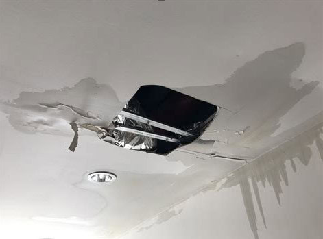 Ceiling water staining caused by a leaking HVAC condensate system