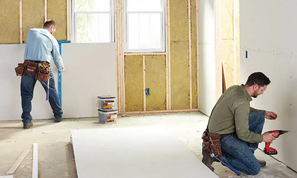Repair technicians restoring cabinetry and interior finishes after water damage